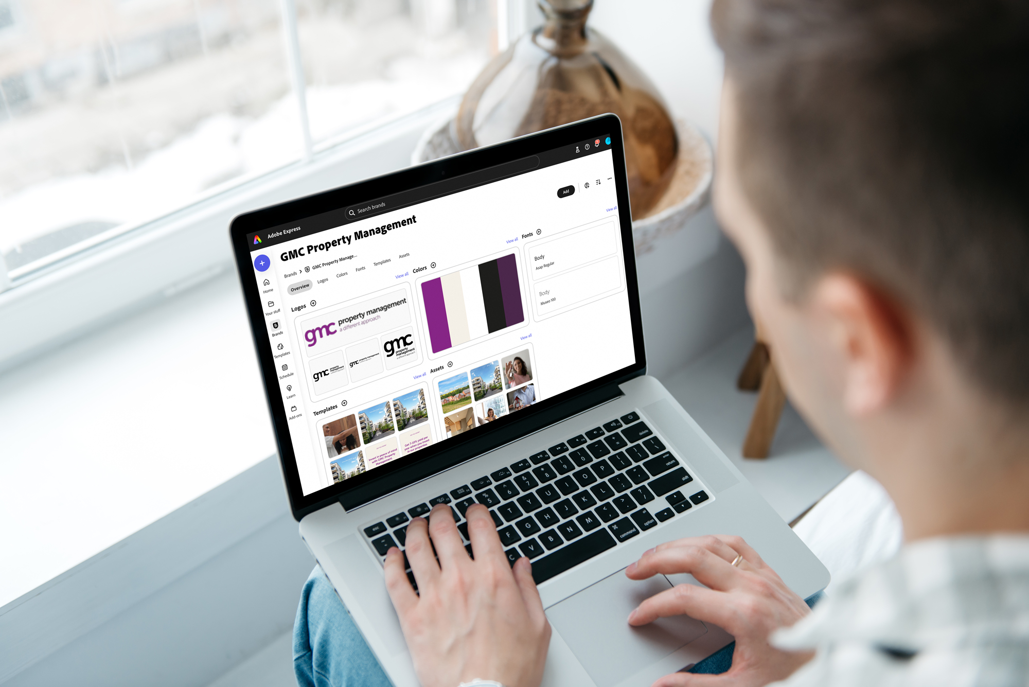 Person using a laptop to view property management website with charts and images.