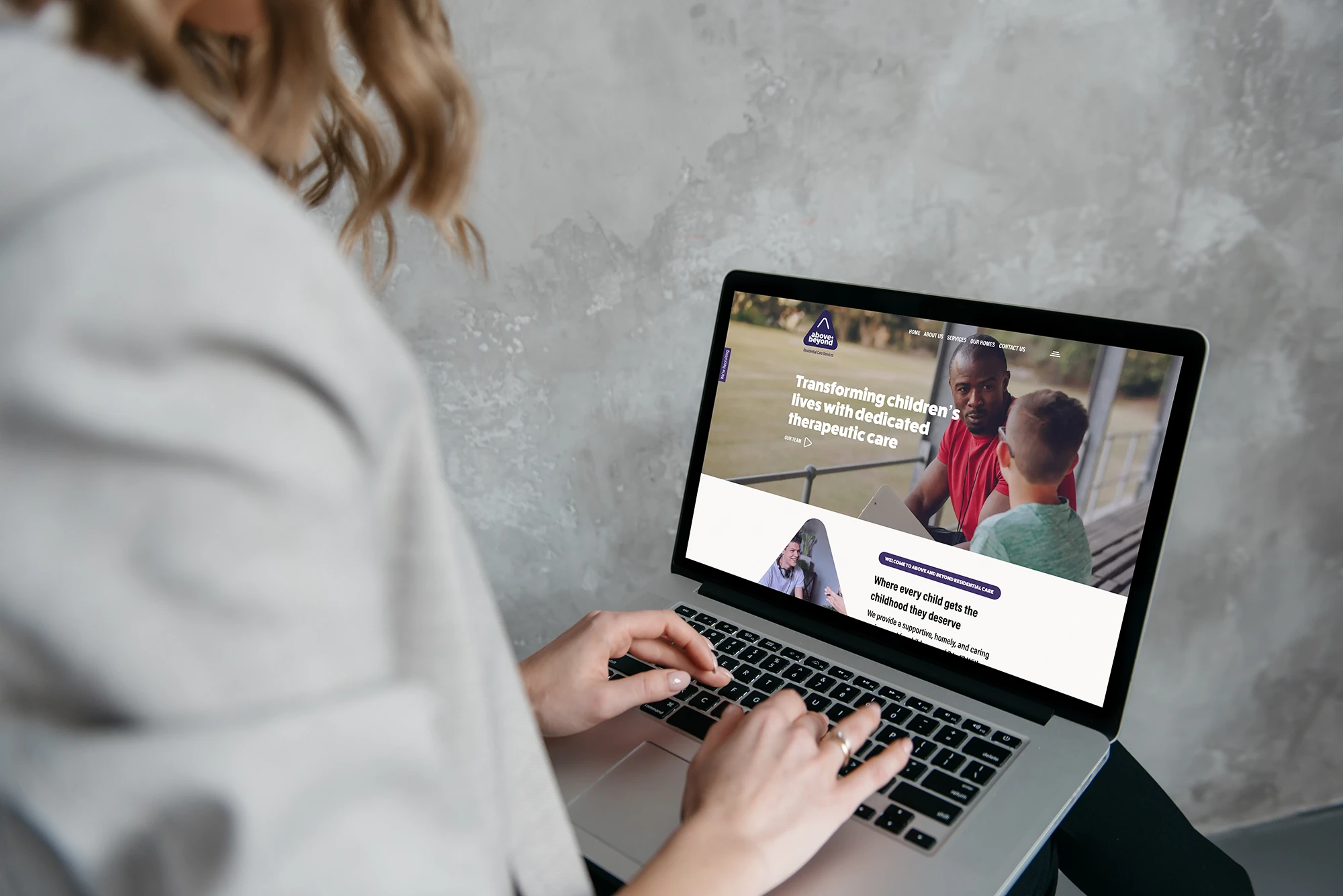 Person using a laptop to access healthcare information on a website.
